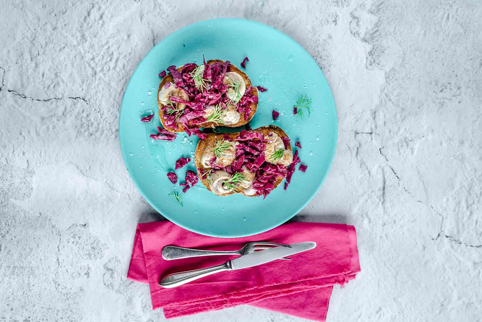 Herring melt crostini with pickled red cabbage