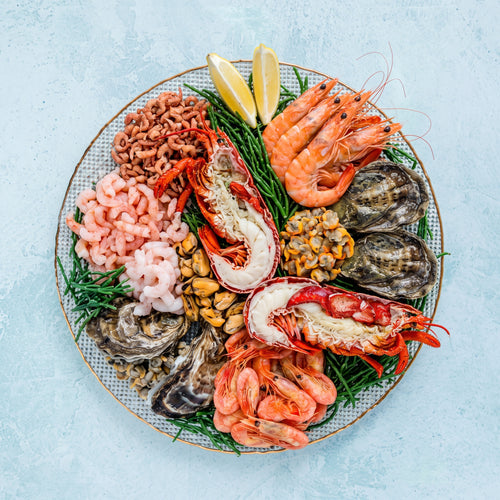 XL shellfish platter with dressed lobster, oysters, crevettes, prawns, cockles and mussels on ice