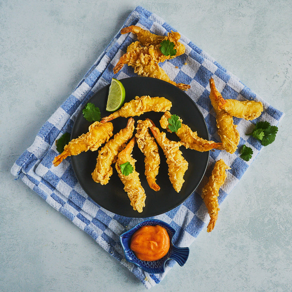 Tempura Prawns displayed on a black plate with a sriracha mayonnaise dip