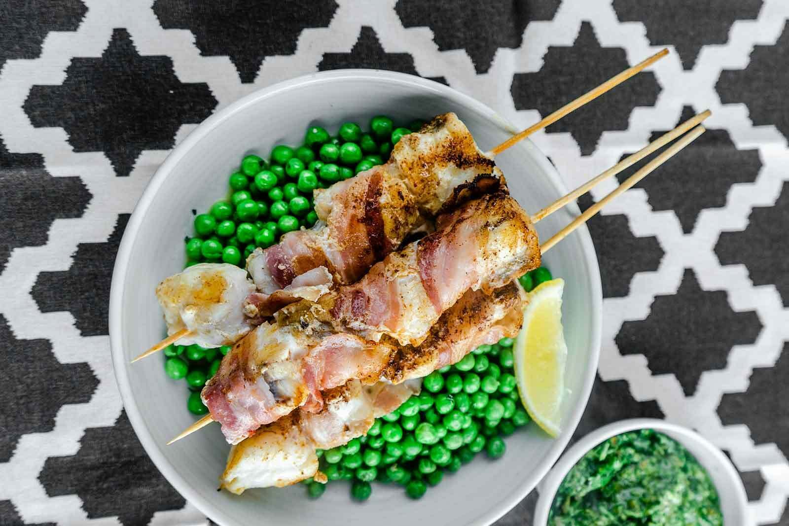 Monkfish and bacon kebabs with minty peas and salsa verde